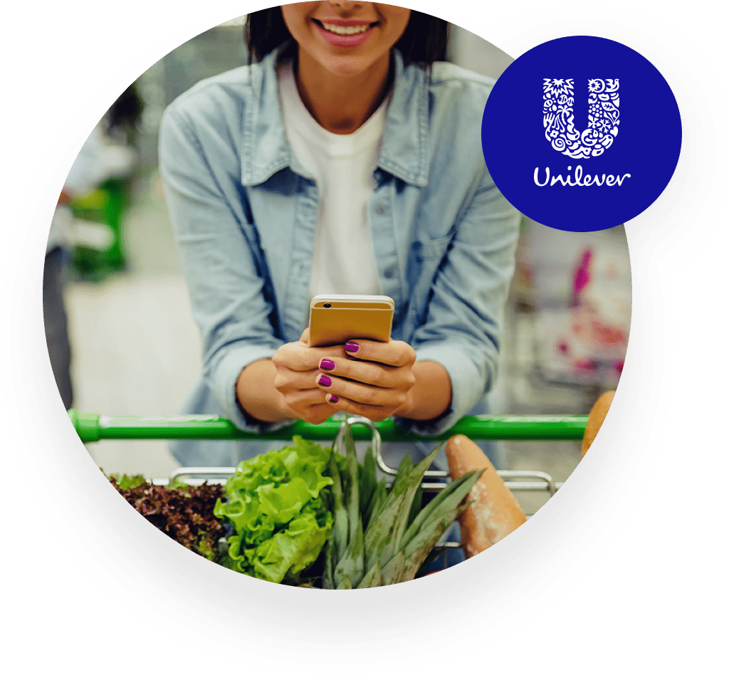 Woman holding her smarthpone smiling Unilever logo